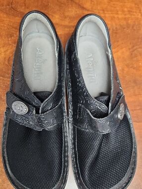 Alegria Black Embossed Leather Slip-On Mules with Decorative Button